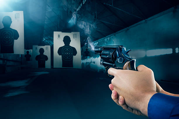 istock Police officer firing a gun at shooting range 487627216