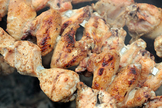 istock Chicken on the grill to cook 487634532
