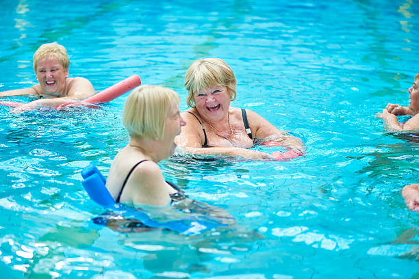 istock laughing and joking senior water aerobics 487635286