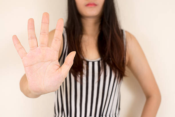 istock woman showing her denial with NO on her hand. 487636792