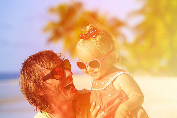 istock father and cute little daughter at beach 487647366