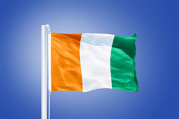 istock Flag of Cote d'Ivoire flying against a blue sky 487648196