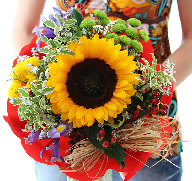 Woman holding beautiful birthday flower with sunflower stock photo