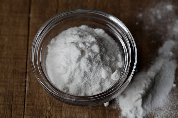 istock Baking soda, Sodium bicarbonate on wooden table 487649502