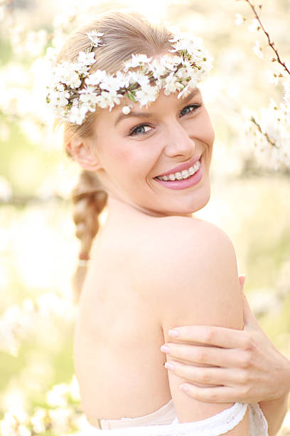 istock beautiful woman with spring flowers 487652377