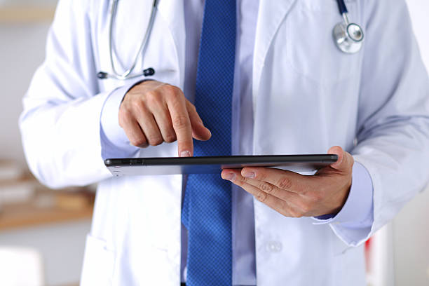 istock Male medicine doctor holding digital tablet pc 487654088
