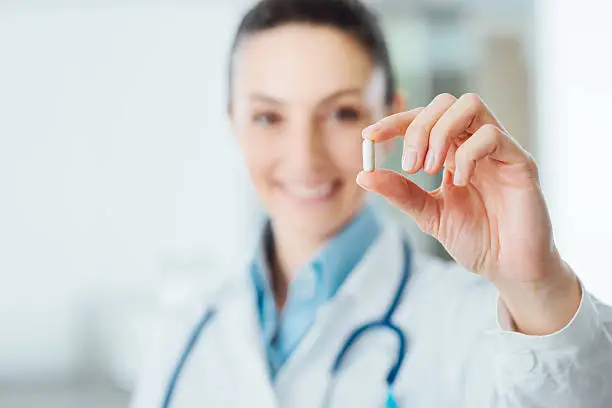 Photo of Pharmacist holding a pill