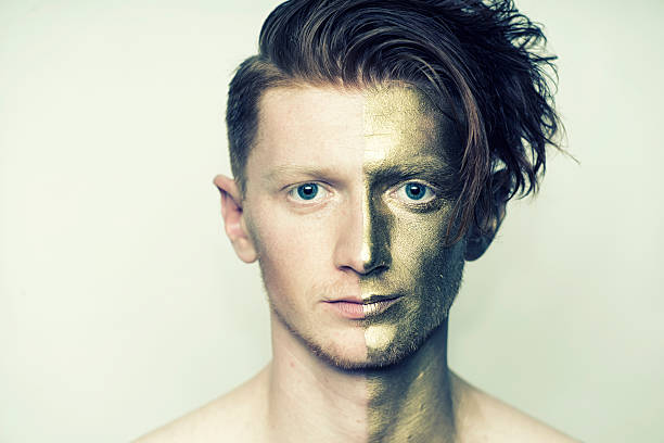istock Portrait of man with golden face 487655842