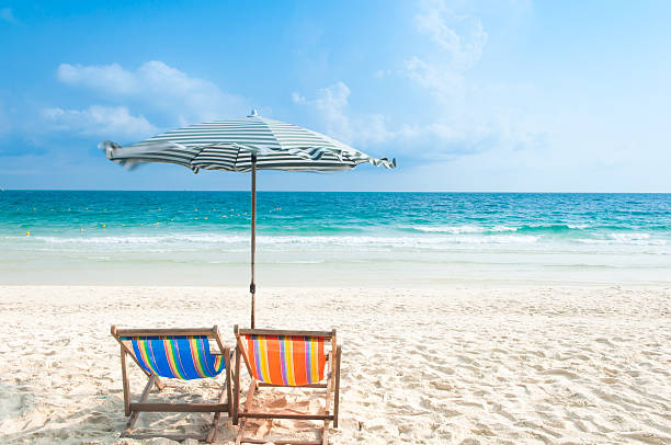 istock Two Chairs and Umbrella at the beach 487655981