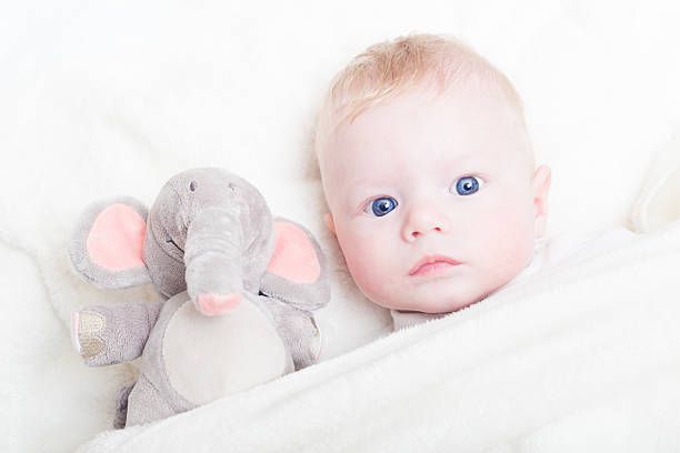 istock Baby with plush toy. 487660460