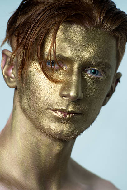 istock Closeup of golden man 487660990