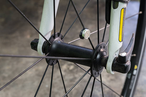 istock Closeup of a bicycle wheel on cement floor. 487667038