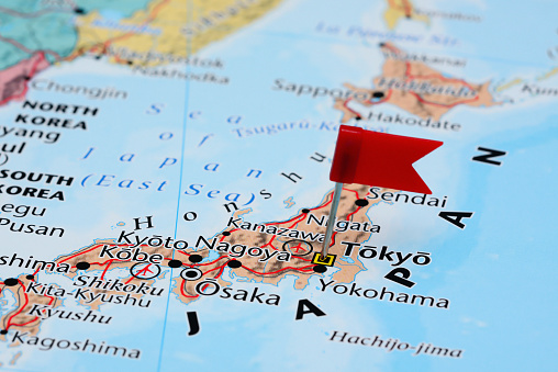 Photo of pinned Tokyo on a map of Asia. May be used as illustration for traveling theme.