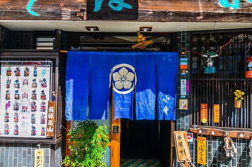 Takayama, Japan - April 14, 2014: A local Japanese restaurant decorated with noren or Japanese traditional fabric at entrance. 