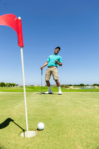 istock African golfer disappointed about his putt 487667743