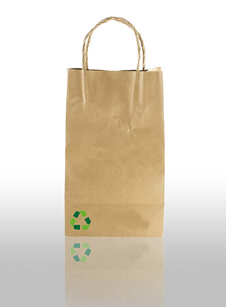 istock paper bag on white with shadow  and recycle symbol. 487667805
