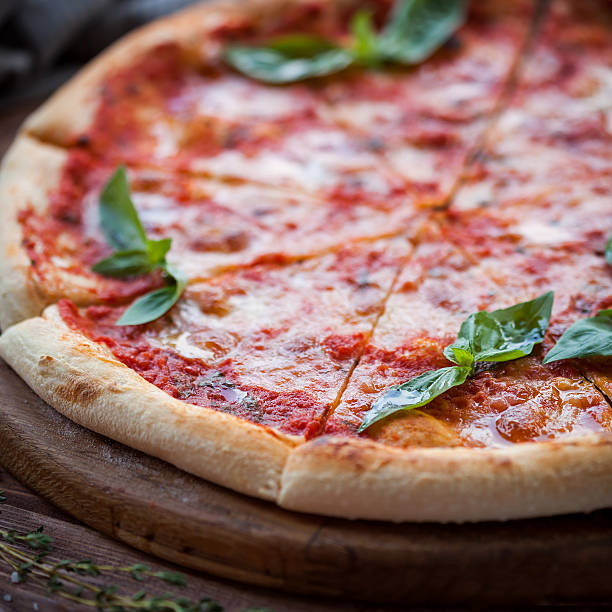 istock Italian pizza with basil leaves 487668008