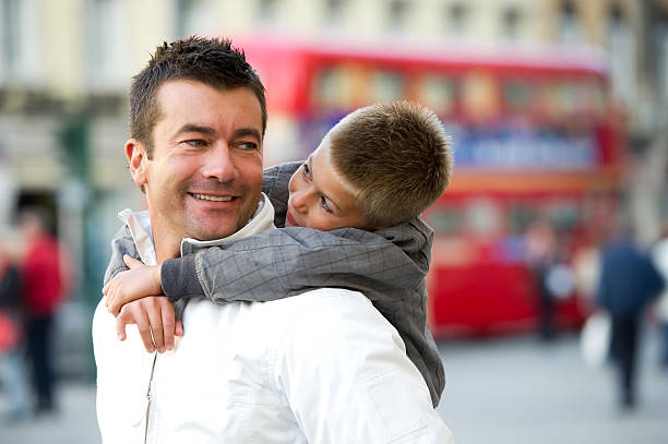 Father And Son Playing Piggy Back
