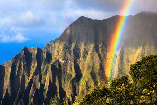 Rainbow over the Na Pali Coast at sunset, photographed from Koke'e State Park on the island of Kauai, Hawaii, USA.