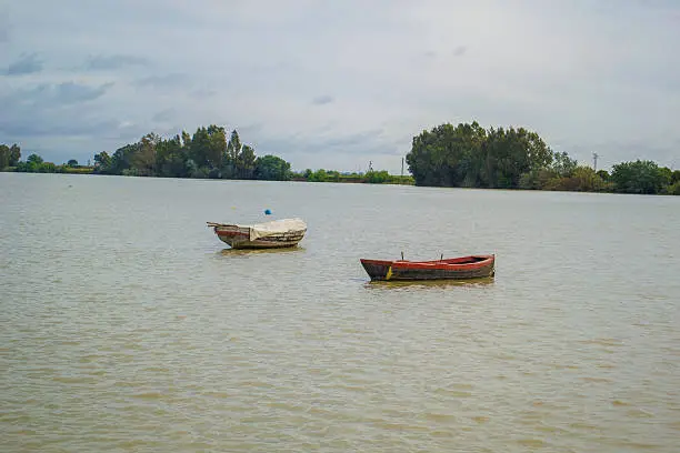 Lonely boat on the river in a cloudy day