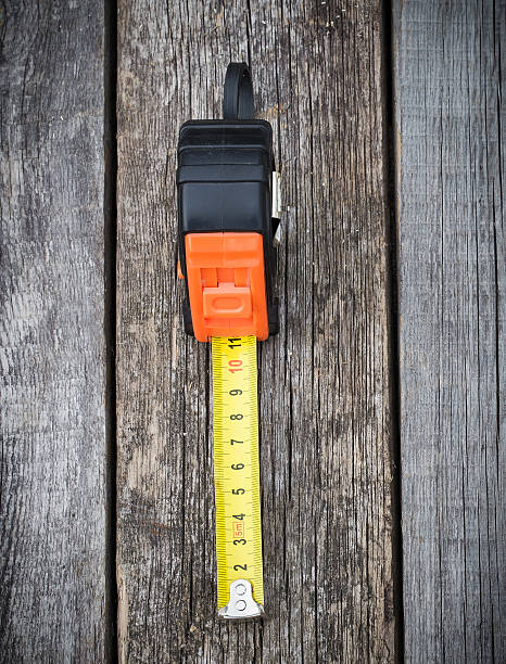 istock Measuring tape on a wooden board 487671476