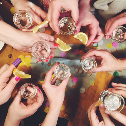Group of woman drinking tequila shots