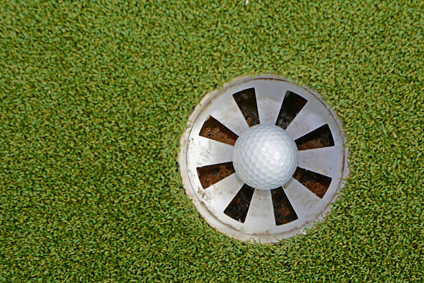 istock Golf ball staying in the hole 487671848