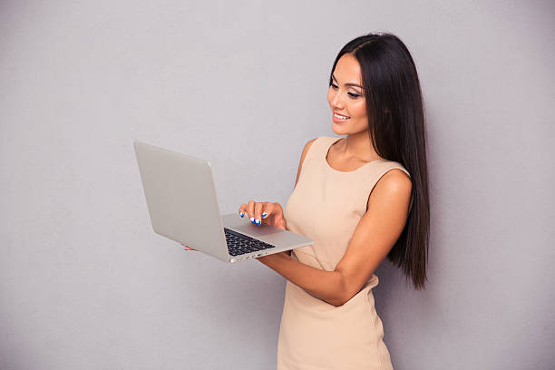istock Portrait of a smiling woman using laptop 487671968