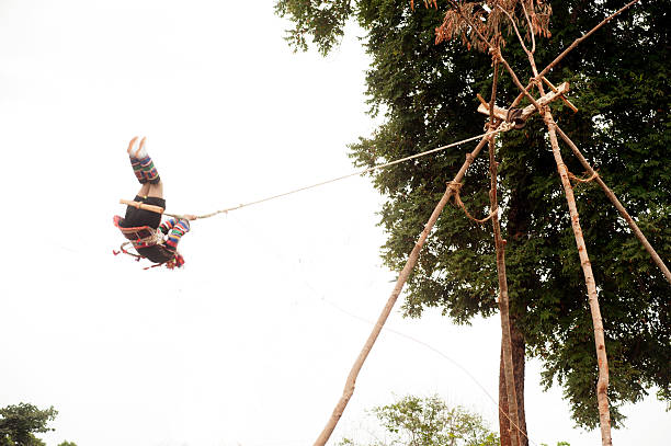 Chiang Rai,Thailand-August 29,2015: The teen Akha hill tribe minority in traditional clothes swing in the air as they honour their ancestors and ask the gods for a good harvest .The Swing Festival is pretty much about women and fertility on August 29,2015 at Doi Mae Salong mountain in Chiang Rai Province,Northern of Thailand.
