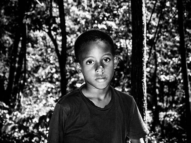 istock caribbean boy in the woods 487672363