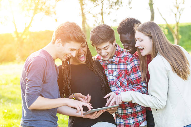 istock Teenage Friends using Digital Tablet at Park 487672449