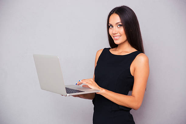 istock Portrait of a smiling beautiful woman using laptop 487672522