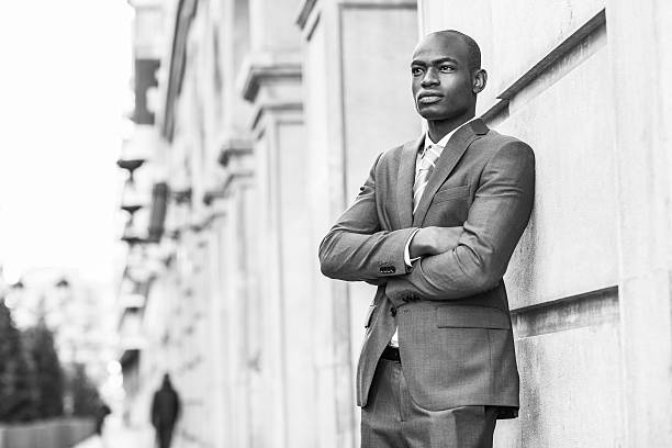 istock Handsome black man wearing suit in urban background 487672568
