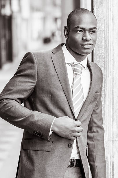 istock Handsome black man wearing suit in urban background 487672570