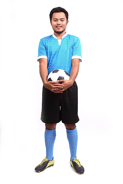 istock Young soccer football player on white 487673287