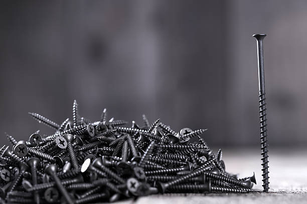 istock Pile of black screws 487673458