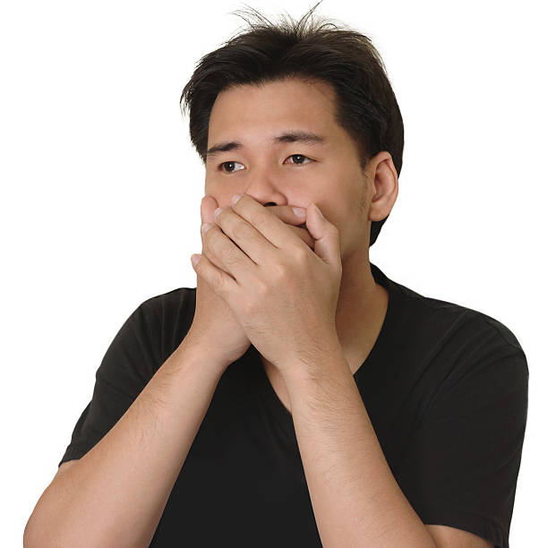 istock Asian Man Covering His Mouth with His Hands 487673544