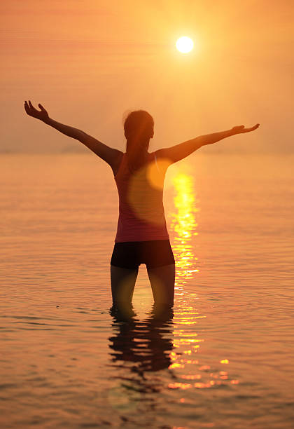 istock woman seaside sunrise 487673947