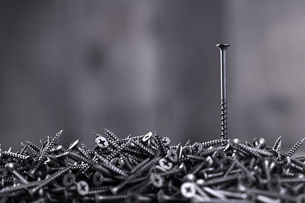 istock Pile of black screws 487674310