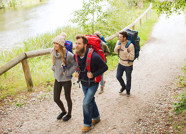 istock group of smiling friends with backpacks hiking 487676950