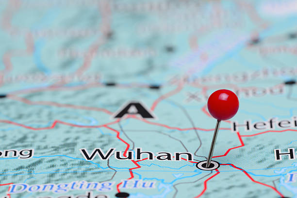 Wuhan pinned on a map of Asia Photo of pinned Wuhan on a map of Asia. May be used as illustration for traveling theme. button sewing item photos stock pictures, royalty-free photos & images
