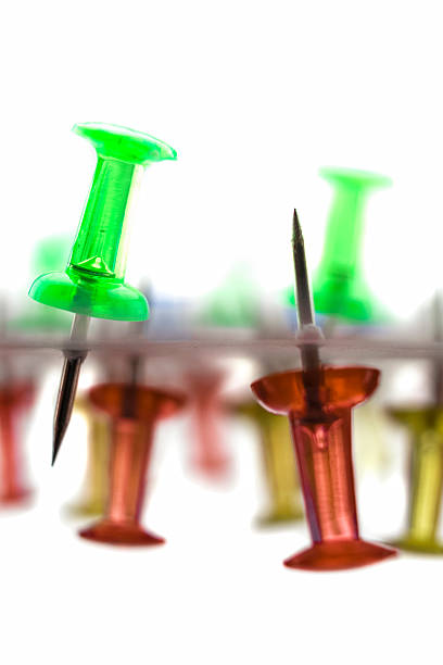 istock Against each other, red against green pin 487677950
