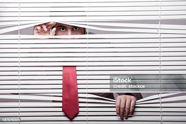 Man Watching Through Window Blinds Stock Photo - Download Image Now - Window Blinds, Manager, Office