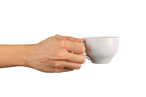 Hand picking up a cup of coffee, isolated on white.