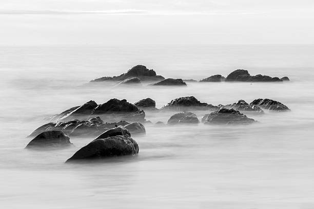 istock Black coast. Beautiful daytime long exposure photo 487679406