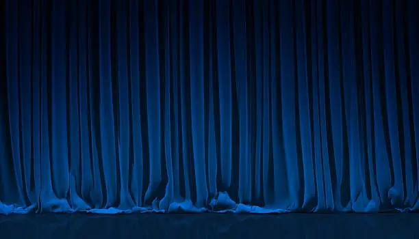 Blue curtain on theater or cinema stage.