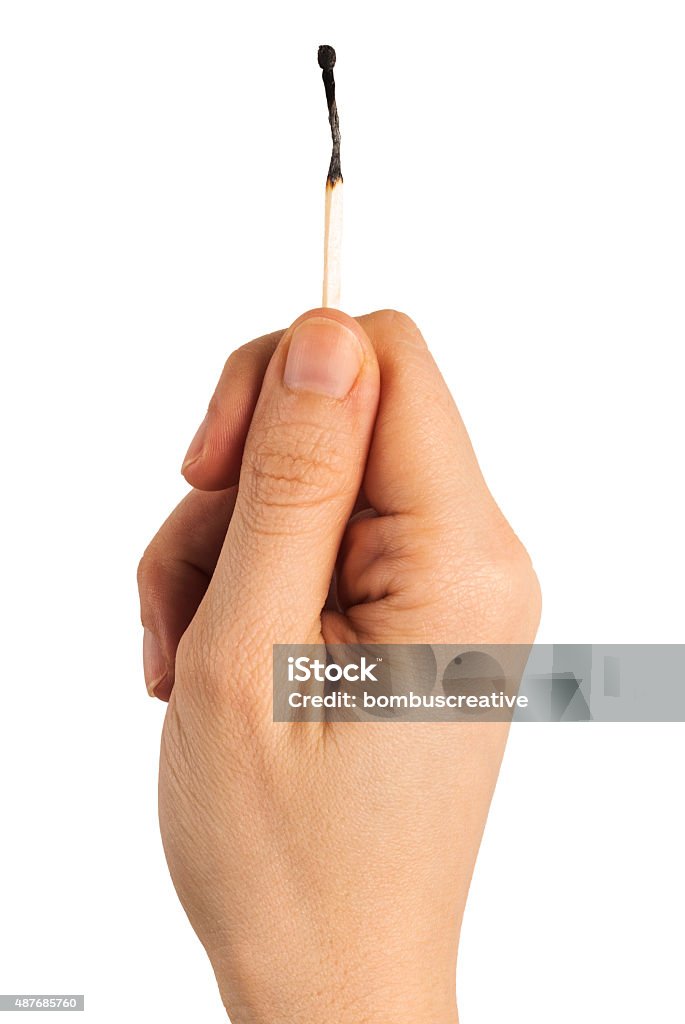 Delicate Match A burned match being held by two fingers delicatly. Isolated on white. 2015 Stock Photo