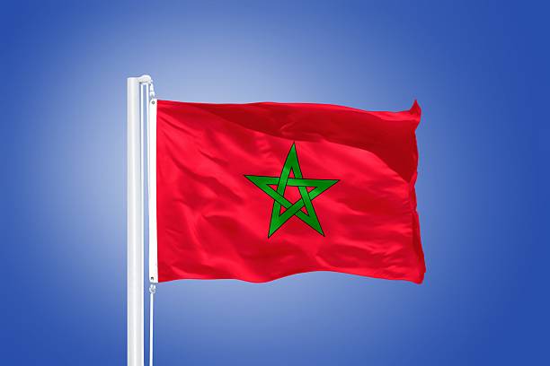 istock Flag of Morocco flying against a blue sky 487685868
