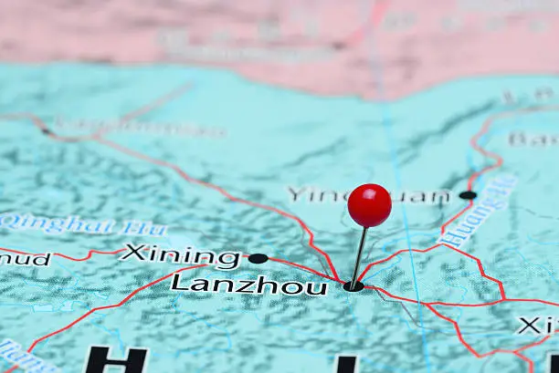 Photo of pinned Lanzhou on a map of Asia. May be used as illustration for traveling theme.