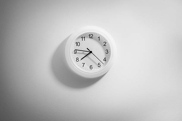 istock black and white clock hanging at the wall with space 487688992